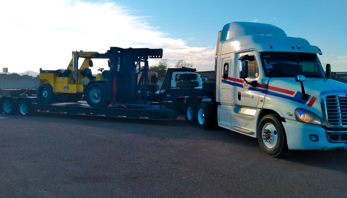 AG Logistics flatbed truck carrying industrial equipment